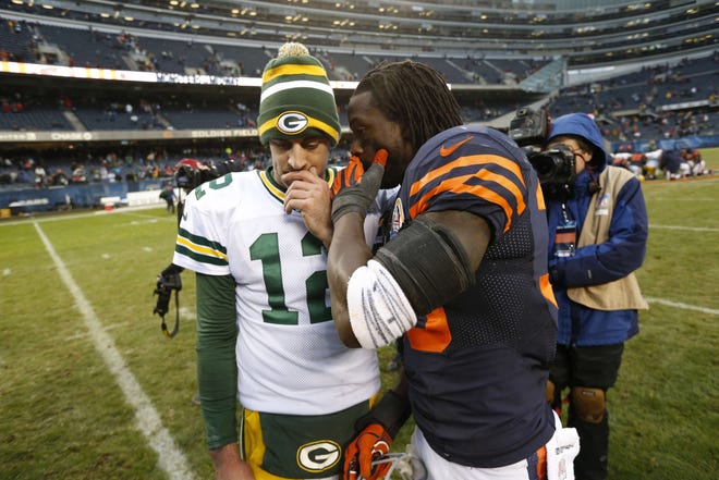 Chicago Bears cornerback Charles Tillman has a few words with Green Bay Packers quarterback Aaron Rodgers after their game Sunday, Dec. 16, 2012, in Chicago. The Packers won 21-13 to clinch the NFC North division title.