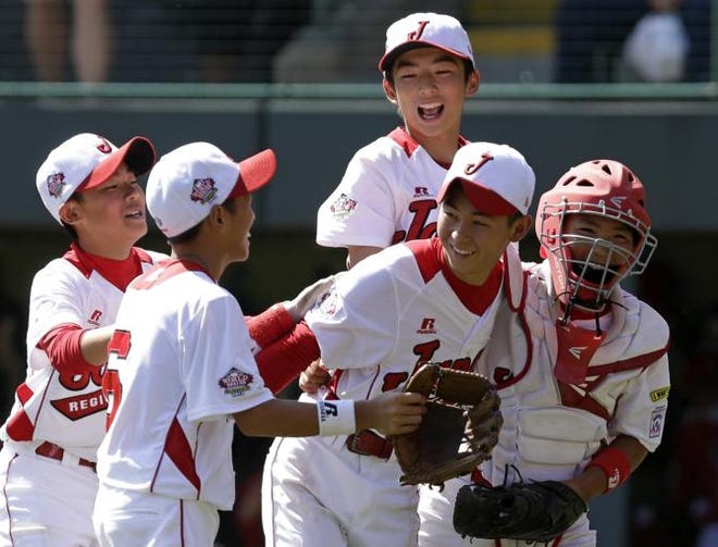 Tokyo, Japan, pitcher Kazuki Ishida, second from right, celebrates with teammates after getting the final out of a 3-2 win over Tijuana, Mexico in the International Championship baseball game at the Little League World Series tournament in South Williamsport, Pa., Saturday, Aug. 24, 2013. The team from Tokyo, Japan won 3-2.
