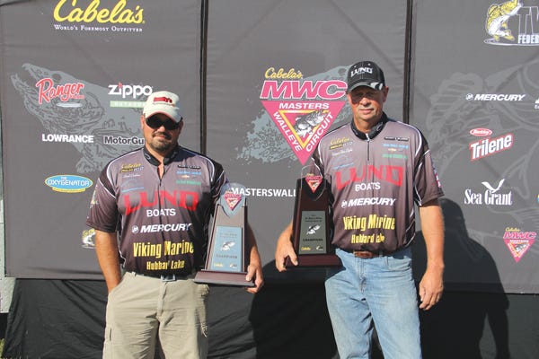 Erich Carlson and Wayne Van Dyke celebrate their first place finish Friday at the conclusion of the Cabela’s Master Walleye Circuit competition. The duo combined to deliver 10 fish — weighing 60.02 pounds — during the two-day competition with an average of better than 6-pounds per fish.