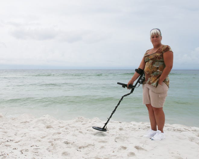 Barbara Roth-Holcomb, owner of White's Metal Detectors, poses for a portrait on the beach in Panama City Beach on Friday.