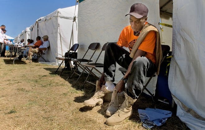 A veteran tries on a new pair of shoes given to him at the 2011 STANDDOWN at the Bucks County Government Services Complex in Bristol Township.