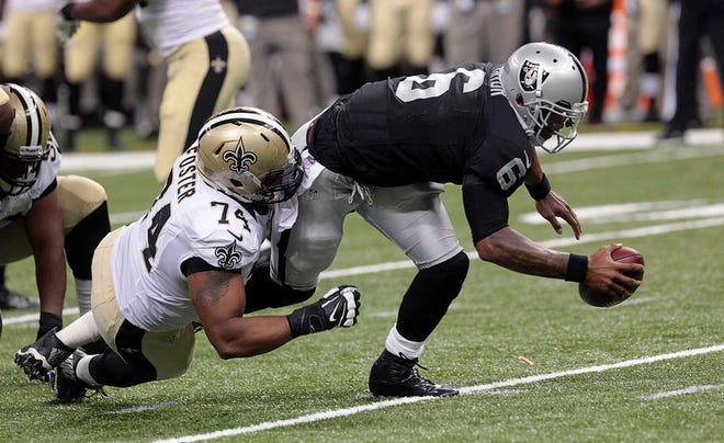 Oakland Raiders quarterback Terrelle Pryor (6) is sacked by New Orleans Saints defensive end Glenn Foster (74) in the second half of an NFL preseason football game at the Mercedes-Benz Superdome in New Orleans, Friday, Aug. 16, 2013. (AP Photo/Matthew Hinton)
