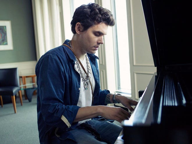 This Aug. 12, 2013 file photo shows singer-songwriter John Mayer sits at a piano in New York. Mayer is releasing his sixth album, “Paradise Valley,” on Tuesday, Aug. 20. It features collaborations with his singer-girlfriend Katy Perry and R&B singer Frank Ocean. (Photo by Victoria Will/Invision/AP)