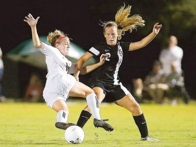 Southeastern University #2 Danielle Alvey trips up Polk State College #10 Rebecca Reynolds during their women's college soccer match at the Lake Myrtle Sports Complex in Auburndale, Florida August 24, 2013.