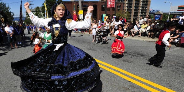 Jazzmin Wall gets her dress spinning on Columbia Street in Fall River during Saturday's Feast of the Holy Ghost parade.