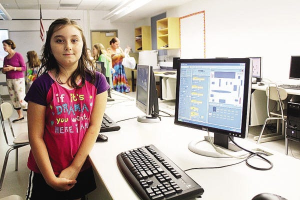 Zoe Iandoli, 9, stands next to a computerized maze she created over the summer as part of Wareham’s Summer C.A.R.E. Camp program.