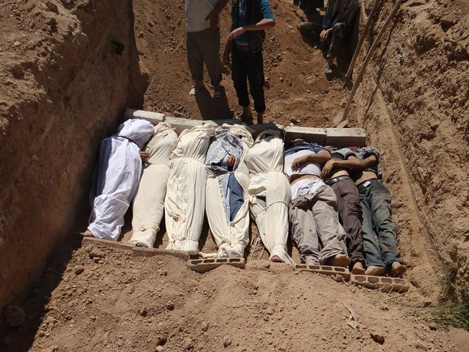 FILE- This Aug. 21, 2013, file image provided by by Shaam News Network, which has been authenticated based on its contents and other AP reporting, purports to show several bodies being buried during a funeral in a suburb of Damascus, Syria. A senior administration official said Sunday, Aug. 25, 2013, that there is Òvery little doubtÓ that a chemical weapon was used by the Syrian regime against civilians in an incident that killed at least a hundred people last week, but added that the president had not yet decided how to respond. (AP Photo/Shaam News Network, File)