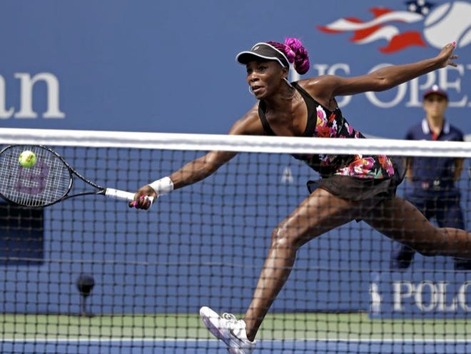 Venus Williams returns a shot to 12th-seeded Kirsten Flipkens on Monday during the first round of the 2013 U.S. Open in New York. Williams defeated Flipkens 6-1, 6-2.
(David Goldman | The Associated Press)