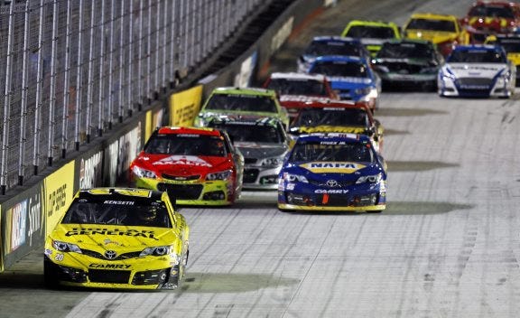 AP PHOTO
Matt Kenseth (20) heads down a straight in front of Jeff Gordon, second row left, Brian Vickers, second row right, and others during the NASCAR Sprint Cup Series auto race Saturday night at Bristol Motor Speedway in Bristol, Tenn.