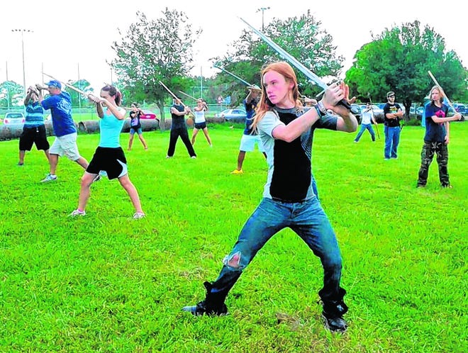 Kei Bland, 
13, practices movements with his sword at auditions for the 10th Sarasota 
Medieval Fair. About 50 other sword-wielding enthusiasts auditioned this 
past weekend for the fair, which will take place each weekend from Nov. 9 
until Nov. 24.
STAFF PHOTO /
SHELBY WEBB