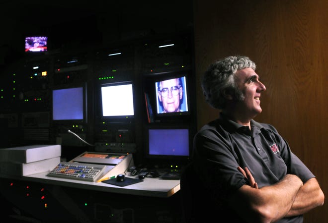 Bruce M. Fiene of Worcester appears in the master control room for video editing at WPI.