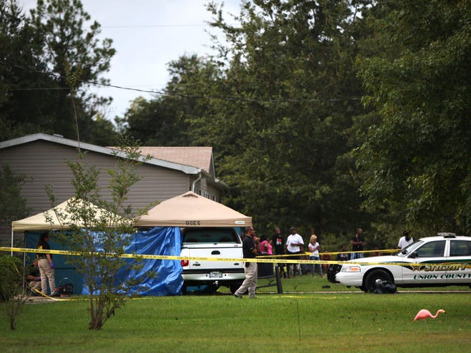 Members of the Florida Department of Law Enforcement crime scene unit investigate the scene where Hubert Allen Jr. was found. Authorities believe he killed two people and injured two others before taking his own life.