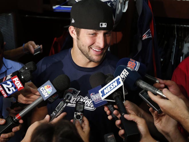 New England Patriots quarterback Tim Tebow speaks to media in the locker room after team football practice in Foxborough, Mass. on Monday
