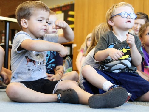 Rachel Rodemann • Times Record Connor Stem, left, and Nathan King with Children’s Paradise Preschool dance to “The Wheels on the Bus” at Windsor Branch Library in Fort Smith on Monday. 
 Rachel Rodemann • Times Record Connor Stem, right, and Colton Kissler with Children’s Paradise Preschool dance to “Head, Shoulders, Knees and Toes” at Windsor Branch Library in Fort Smith on Monday.