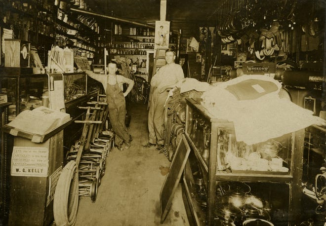 A portrait of W.G. Kelly (right) at the first Kelly Seed & Hardware Store in July of 1912.