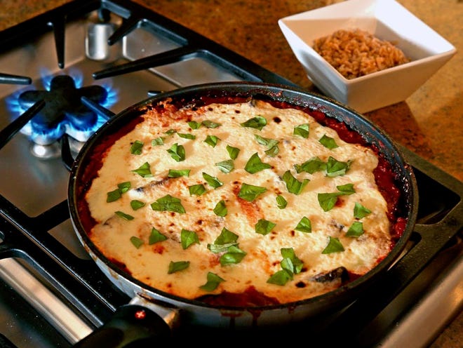 Cutting eggplant  into smaller cubes allows a quicker cooking time to eggplant parmesan.
(AL DIAZ | MIAMI HERALD)
