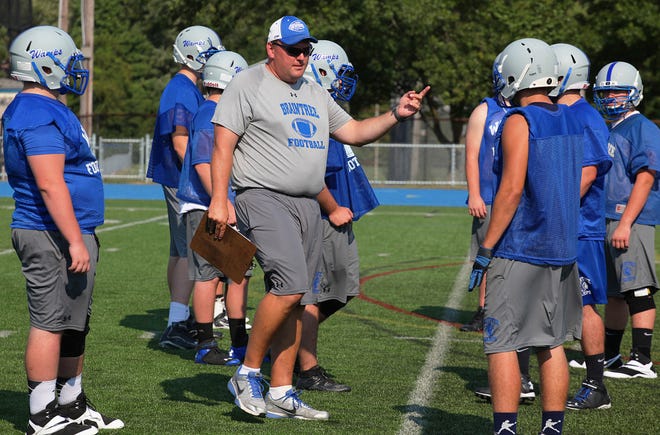 Head coach Brian Chamberlain gives instructions to his players during a recent Braintree High football practice.