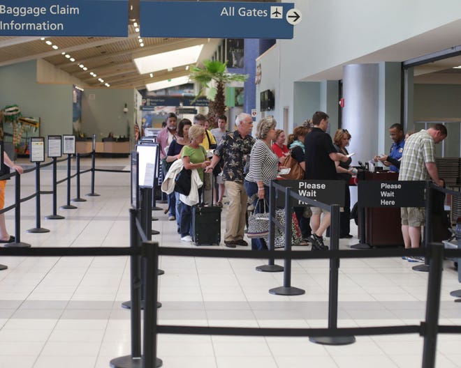 Passengers at the Northwest Florida Beaches International Airport near West Bay wait to go through security before boarding flights in April.