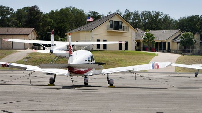 Houses sit just beyond the runway at Lakeway Airpark. Developers in Lakeway plan on completing a new subdivision of eight homes near the airfield.