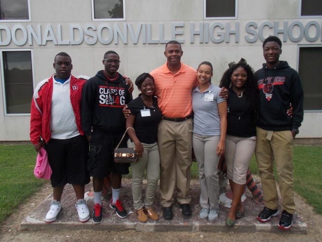 DHS’ now-former Principal Dr. Esrom Pitre takes his last picture with some of the senior class students last week.