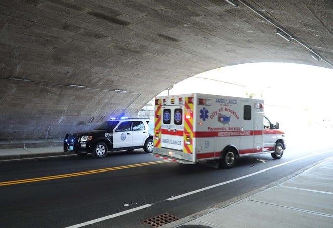 A cruiser and an ambulance respond to a pedestrian accident on Centre Street in Brockton under the railroad bridge.