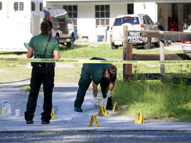 Marion County Sheriff's evidence technicians collect evidence at the scene of death of a man inside a home at 6095 Southeast 180th Ave Road in Ocklawaha, Fla., on Wednesday August 28, 2013.