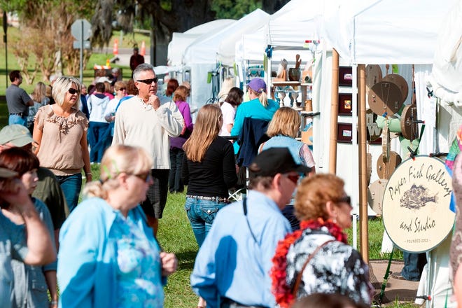Attendees walk through booths during last year's Ocala Arts Festival. The annual event returns Oct. 26-27.