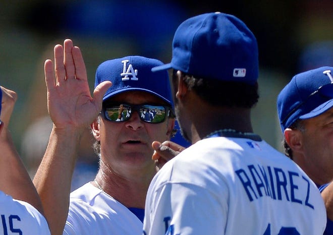 Los Angeles Dodgers manager Don Mattingly, left, congratulates Hanley Ramirez after they defeated the Chicago Cubs 4-0 in a baseball game on Wednesday, Aug. 28, 2013, in Los Angeles.