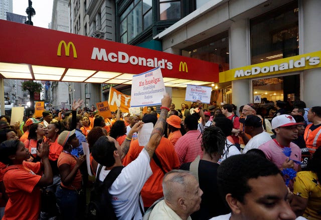 Fast-food workers demonstrate Thursday outside a McDonald’s restaurant on New York’s Fifth Avenue. Organizers say thousands of fast-food workers are set to stage walkouts in dozens of cities around the country Thursday, part of a push to get chains such as McDonald’s, Taco Bell and Wendy’s to pay workers higher wages. (AP photo)