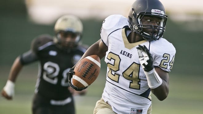 Akins running back Teddy Lowery (24) breaks loose for a 55-yard, first-quarter touchdown run against Crockett on Thursday night. Lowery also scored on a 3-yard run in the game’s final minute as Akins won 26-23.