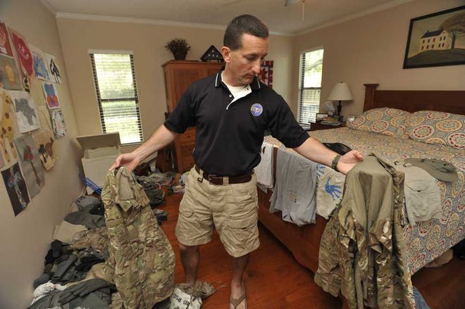 Kevin Frein, a federal prosecutor from Jacksonville, goes through his belongings brought back from his Army Reserves deployment in the Judge Advocate General's Corps in Afghanistan earlier this month.