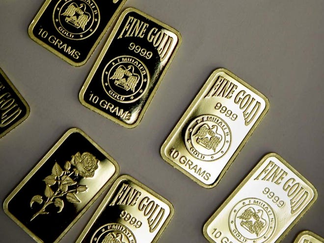 Ten-gram gold bars with a purity of 999.9 have been pressed and stamped with the "Emirates Gold" company logo in Dubai, United Arab Emirates. The precious metal is back on a surge after a slump earlier this summer. (KAMRAN JEBREILI | THE ASSOCIATED PRESS)