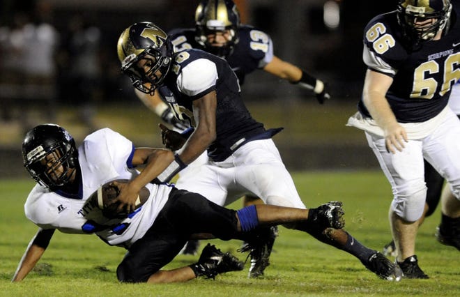 The North Brunswick defense sacks Trask quarterback Dashaun Walker in the fouth quarter of their game Friday night at North Brunswick. The Scorpions shut out the Titans, 47-0.