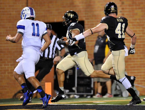 Wake Forest linebacker Brandon Chubb, center, races into the end zone with teammate Mike Olson, right, while pursued by Presbyterian quarterback Tamyn Garrick during the third quarter of Thursday night's game.