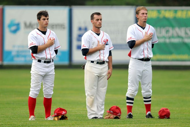 Jacob Robson, Andrew Santomauro and Ryan Stephens stand for the National Anthem before a recent home game.