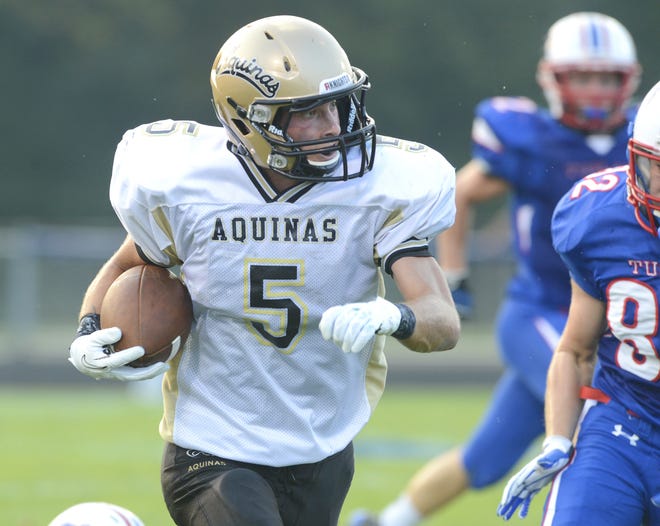 St. Thomas Aquinas’ Sam Pusateri races for a touchdown during Friday’s season opener against Tuslaw.