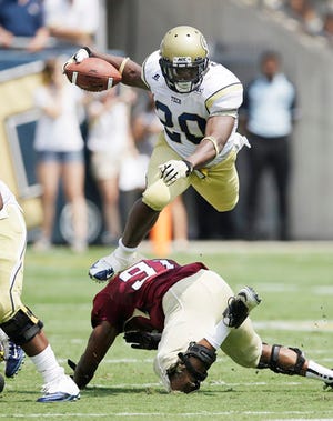 Georgia Tech running back David Sims leaps over Elon defensive lineman Gary Coates in the first quarter.
