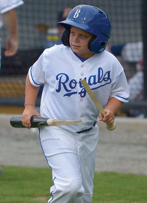 Burlington Royals bat boy Austin Palone collects pieces of a bat after Burlington's Sam Bates shattered it while batting during a game last month. Bates led the Appalachian League with 10 home runs when he received a mid-August promotion. Still, he finished tied for second in the league for homers.
