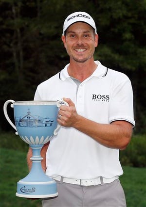 Henrik Stenson, of Sweden, poses with the trophy after winning the Deutsche Bank Championship golf tournament in Norton, Mass., Monday, Sept. 2, 2013. (AP Photo/Michael Dwyer)