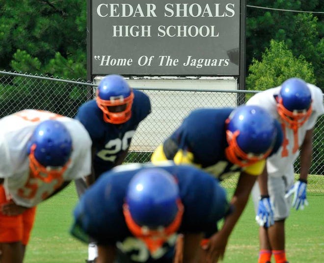The Cedar Shoals football team warms up during summer football practice at Cedar Shoals High School on Wednesday, Aug. 7, 2013.  (Richard Hamm/Staff) OnlineAthens / Athens Banner-Herald