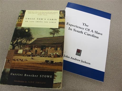 Copies of Harriet Beecher Stowe's "Uncle Tom's Cabin" and John Andrew Jackson's "The Experience of a Slave in South Carolina" are seen in this Aug. 29, 2013 photo taken at the Charleston County Library in Charleston, S.C.
