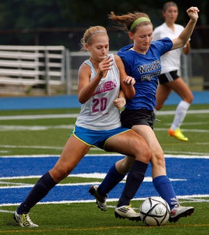 Norwell's Lilly Cleary, left, digs for the ball during a scrimmage against Braintree on Tuesday, Aug. 27, 2013.
