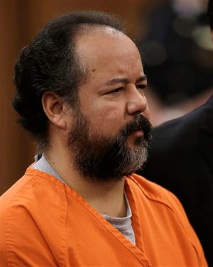 This Wednesday, July 17, 2013 file photo shows Ariel Castro standing before a judge during his arraignment on an expanded 977-count indictment in Cleveland. Castro, who held 3 women captive for a decade, has committed suicide, Tuesday, Sept. 3, 2013. (AP Photo/Tony Dejak, file)