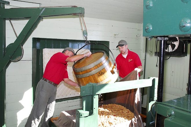 Turning the pressing tray of the Boomer & Boschert press at the Fly Creek Cider Mill. The mill will begin producing cider on Saturday, Sept. 7. PHOTO SUBMITTED