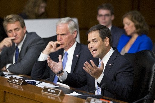 Senate Foreign Relations Committee member Sen. Marco Rubio, R-Fla., (right) questions Secretary of State John Kerry during the committee's hearing on President Barack Obama's request for congressional authorization for military intervention in Syria on Tuesday.
