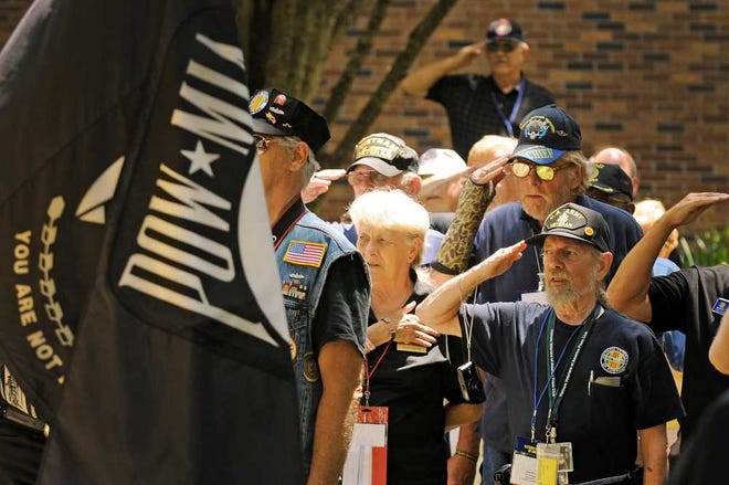 Bob.Self@jacksonville.com Paying tribute. Spectators at the Vietnam Memorial on Aug. 13 saluted during the Pledge of Allegiance. Vietnam Veterans of America brought delegates and their families to Jacksonville for a convention. Jacksonville's Vietnam Memorial was dedicated in 1974.