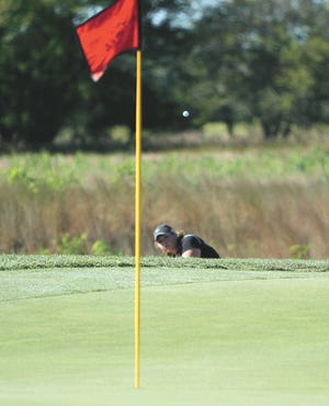 Sturgis’ Taylor Williams hits her approach shot toward the green Thursday at Island Hills.