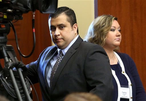 FILE - In this Monday, June 24, 2013 file photo, George Zimmerman, left, arrives in Seminole circuit court with his wife, Shellie, on the 11th day of his trial, in Sanford, Fla. George Zimmerman's wife filed for divorce Thursday, Sept. 5, 2013 less than two months after her husband was acquitted of murdering Trayvon Martin and a week after she pleaded guilty to perjury in his case.