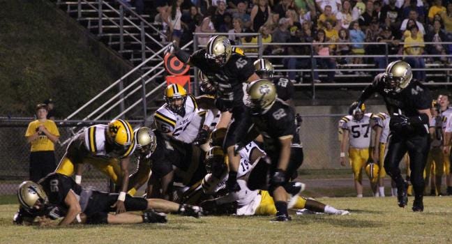 North Gaston's Allen Cisco, Tyler Gonzalez, EJ Banks and Lathan Bumgarner get in on a play during Friday's win over Lincolnton.