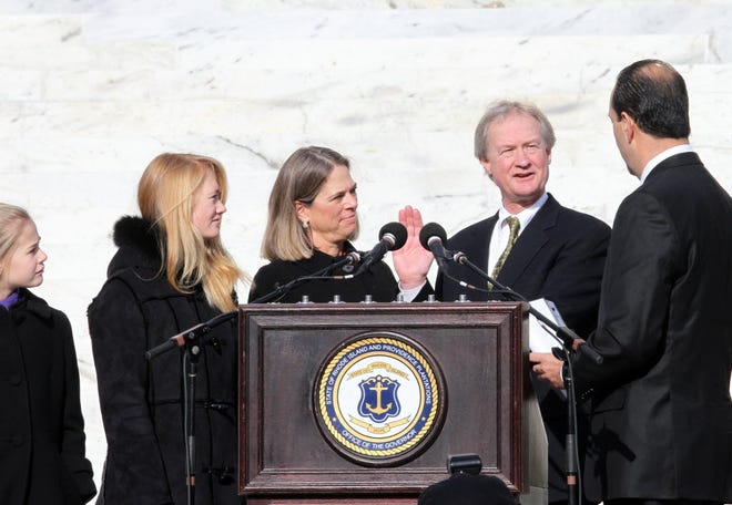 Lincoln Chafee, accompanied by his wife, Stephanie, and daughters Thea, far left, and Louisa, is sworn in as governor of the state of Rhode Island by Secretary of State Ralph Mollis in January 2011.